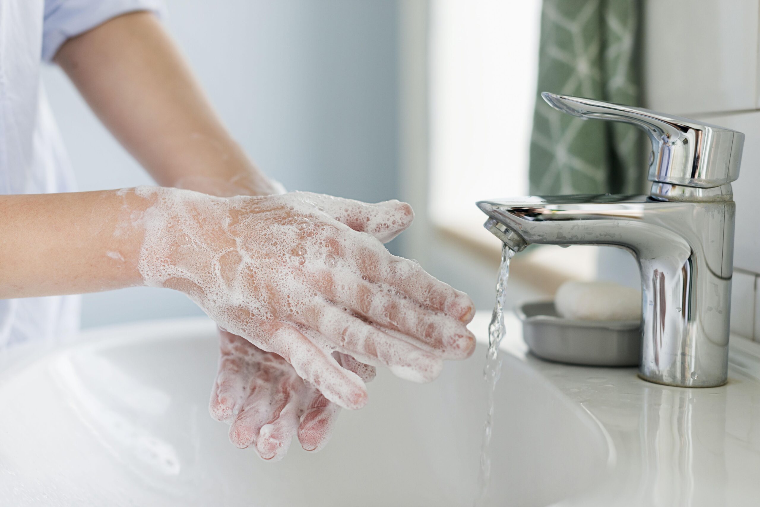 Person washing hands with soap