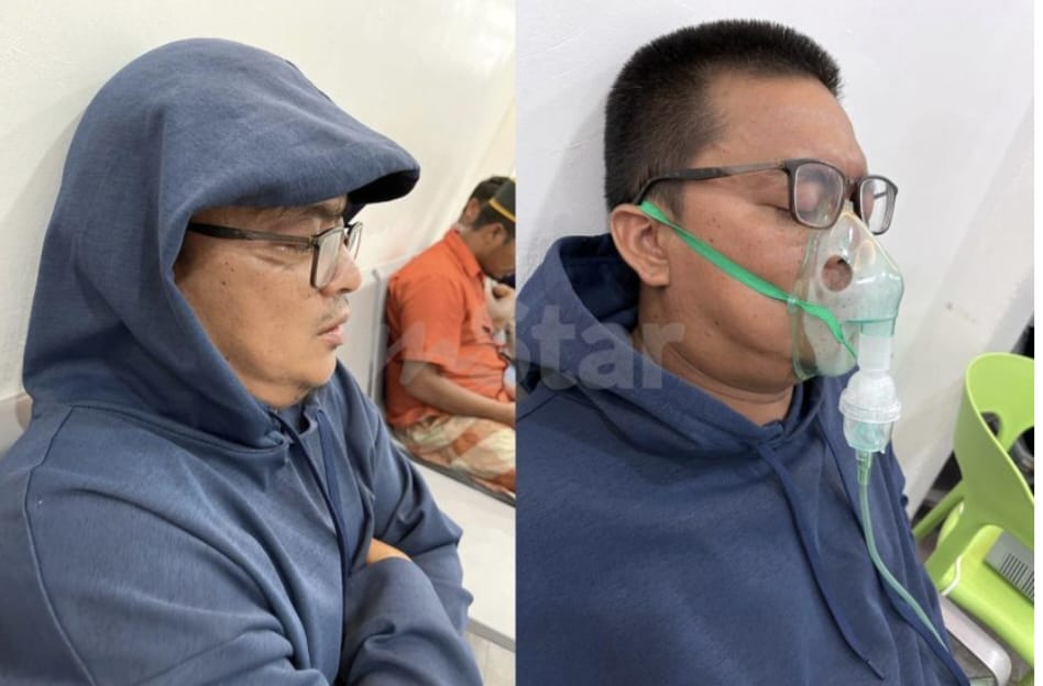 M'sian man breathing through an oxygen mask