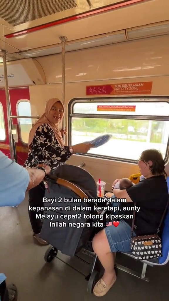 Kindhearted malay woman helps chinese mother & her baby keep cool by fanning her on the bus | weirdkaya
