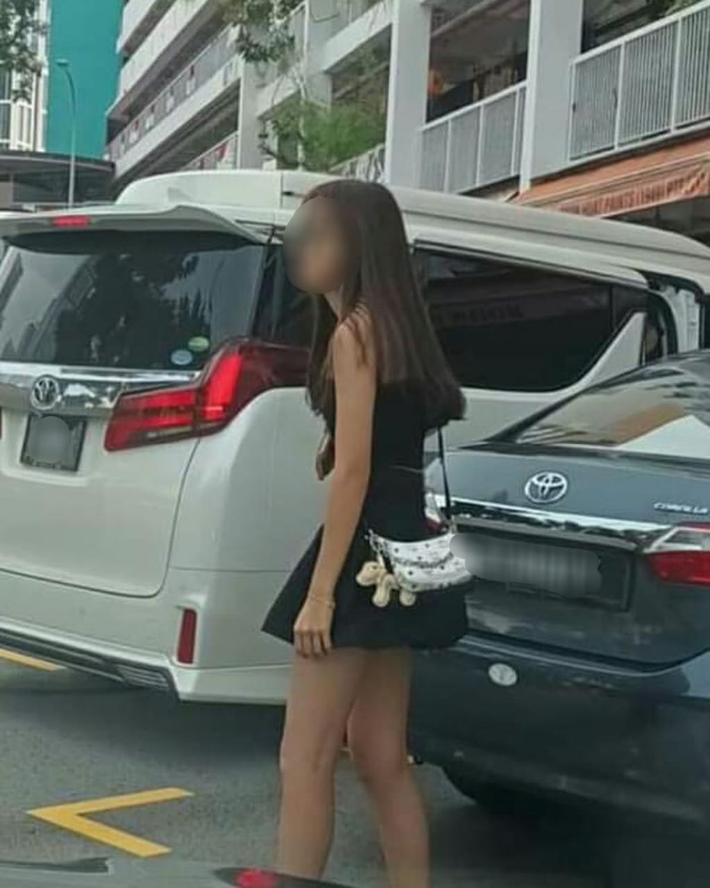 Msian woman waiting for her after she chups the empty parking spot