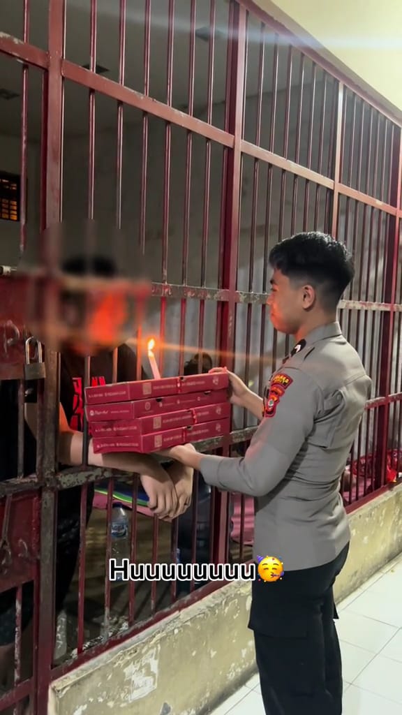 Inmate blowing the candle ion the pizza box