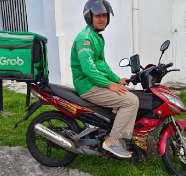 Grab rider sitting on his motorcycle