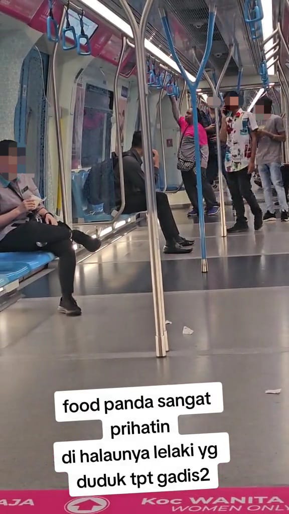 Foodpanda rider showing the pink sign to the male commuter who was sitting at the female coach.