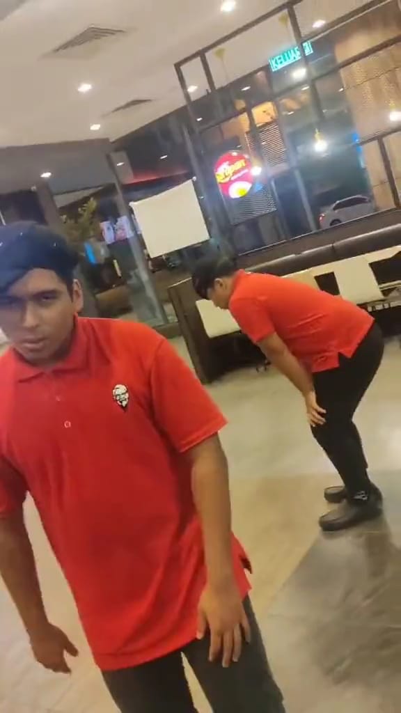 Msian kfc keeps on dancing awkwardly, following the flow of the other staff's rap.