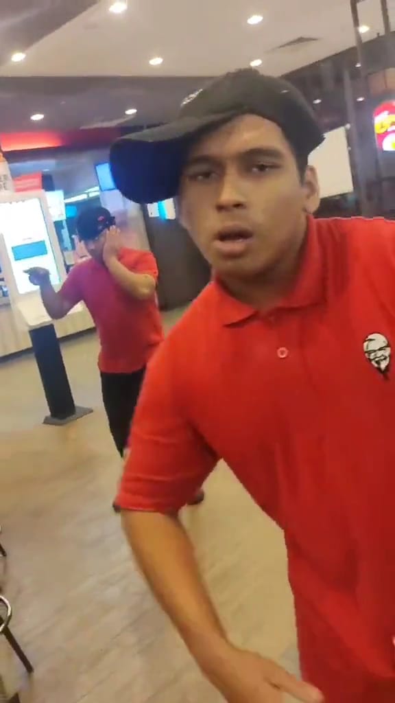 Msian kfc is rapping while another is dancing casually at behind.