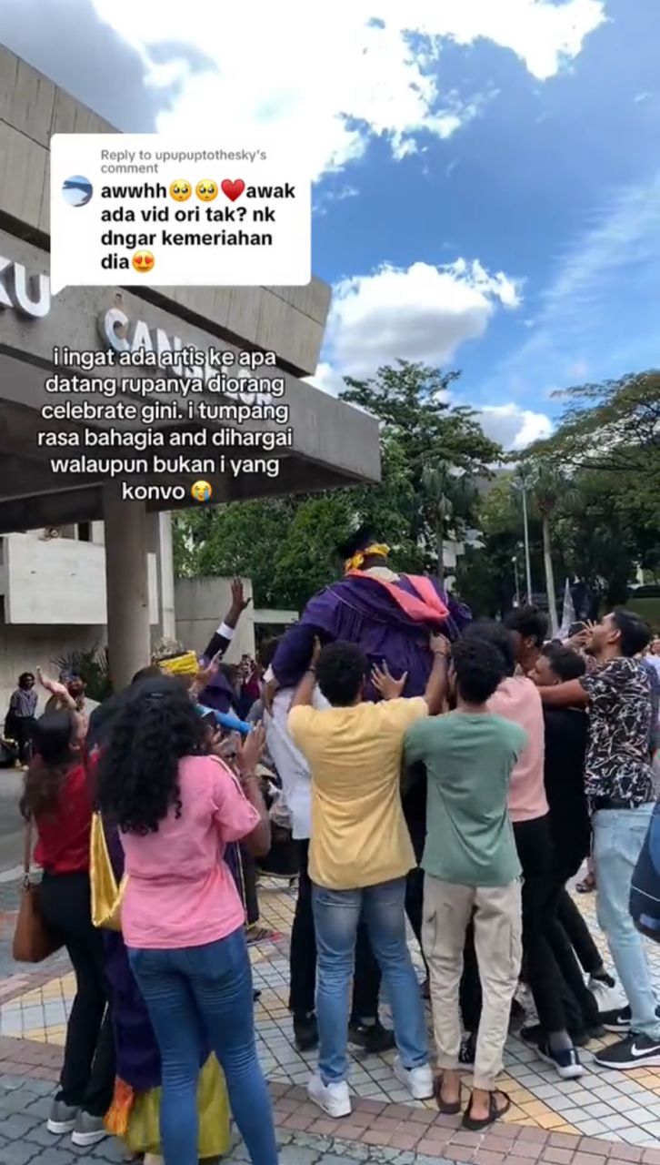 Group of family/friends lifting graduate up in the air