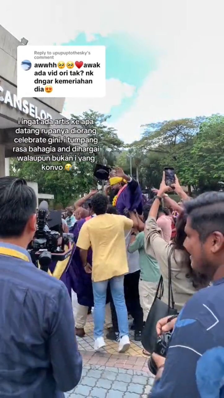 Group of family/friends lifting graduate up in the air