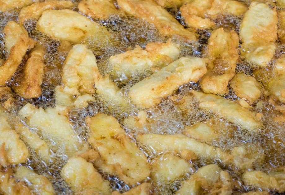 Banana fritters frying in hot oil