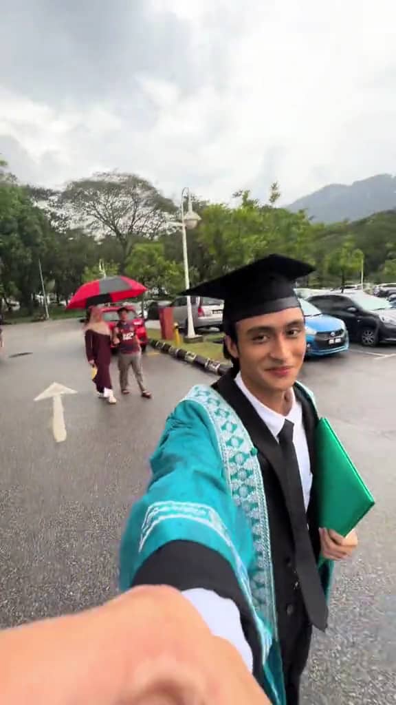Malaysian fresh graduate walks out of the graduation hall after his ceremony.