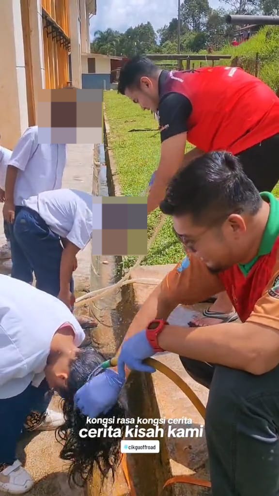 Msian teachers washing the kids hair after cleaning the lice on their hair