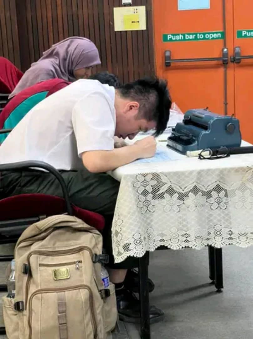 17yo m'sian student using braille typewriter during a program at seberang perai polytechnic.