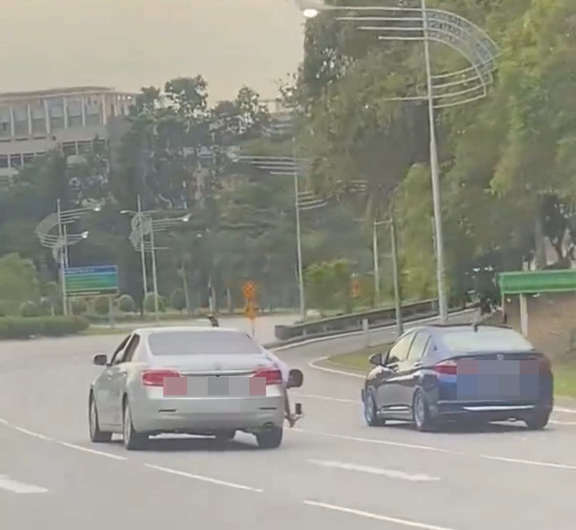 M’sian man leans out of moving car to film honda city