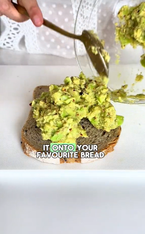 Woman adds petai spread to the bread