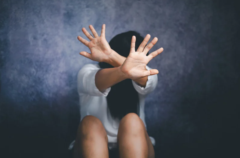 Woman covering her face