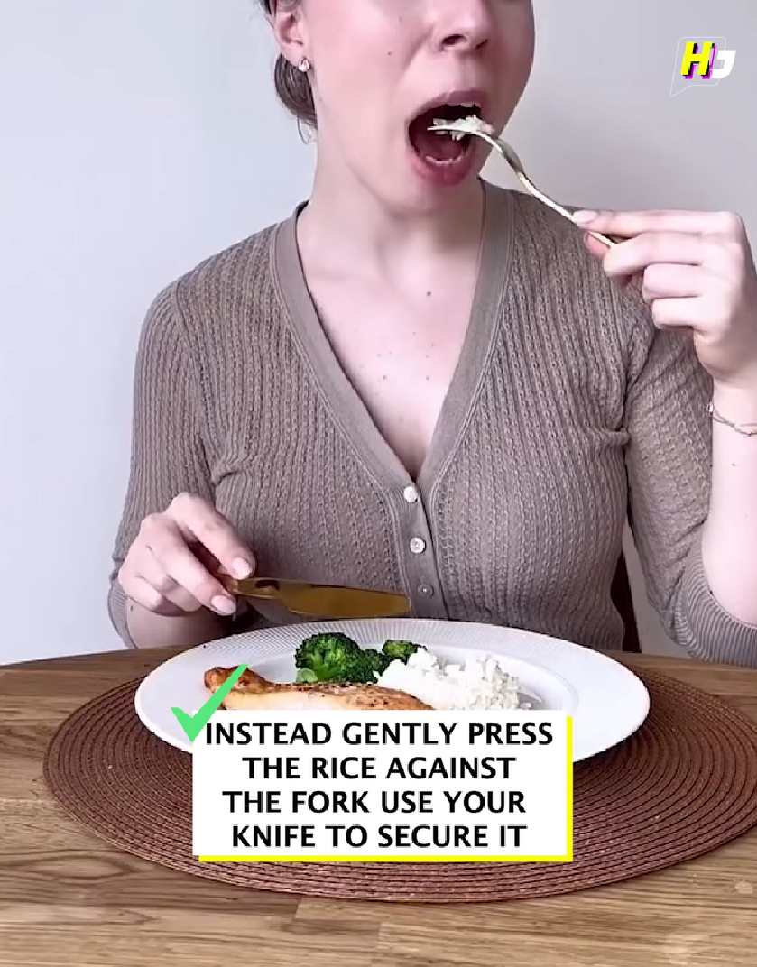 Woman eating rice with fork adn knife