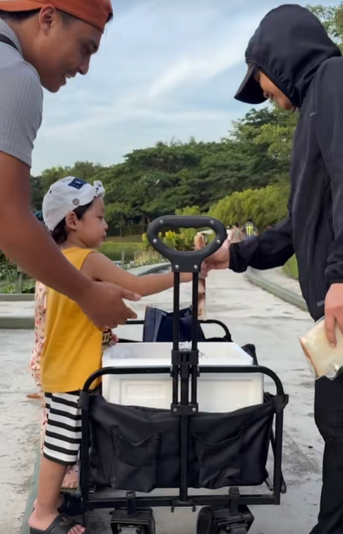 Woman getting free ice cream from 3yo boy