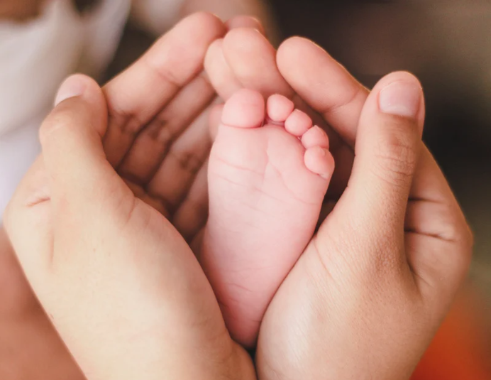 Woman holding baby's feet