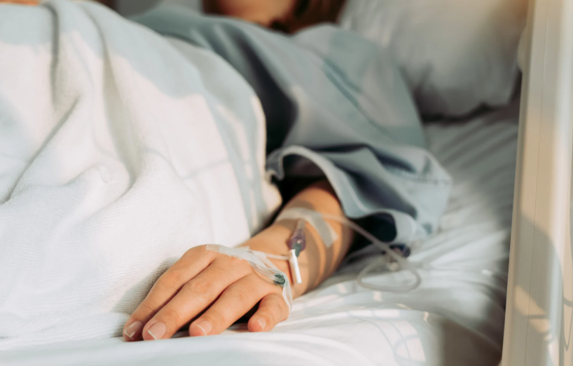 woman on bed with IV