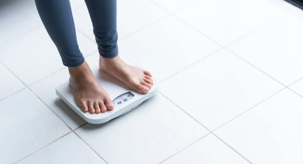 Woman on weighing scale