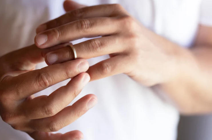 Woman removes ring from her finger