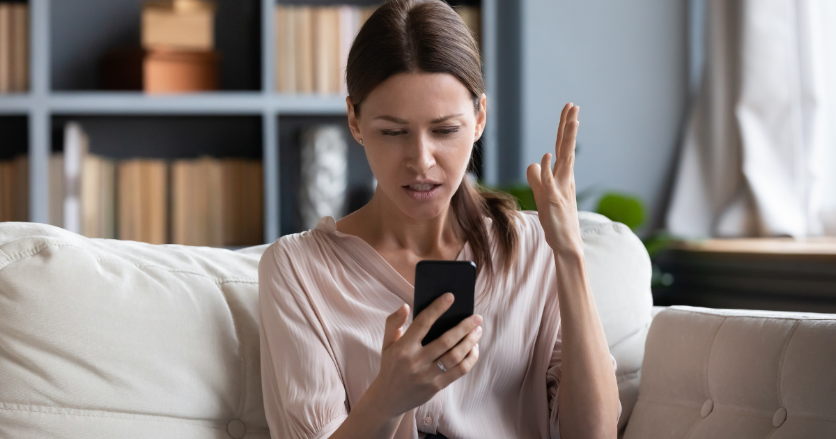 woman shocked looking at his phone
