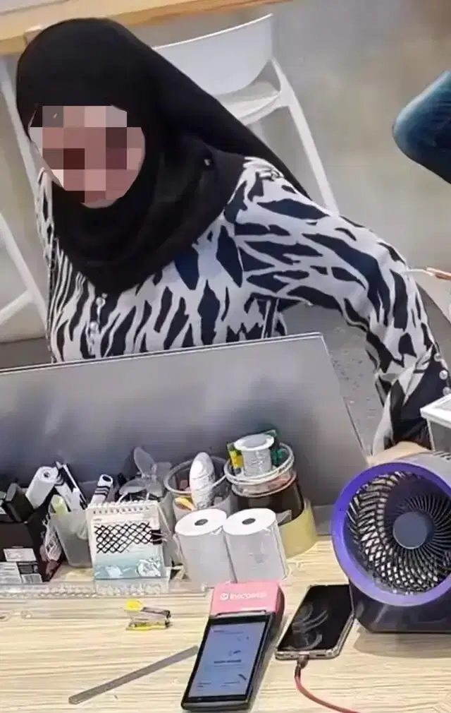 Woman stares at phone lying on the counter