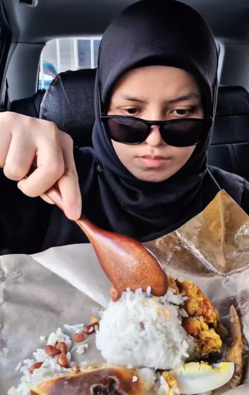 Woman unwraps nasi lemak packet