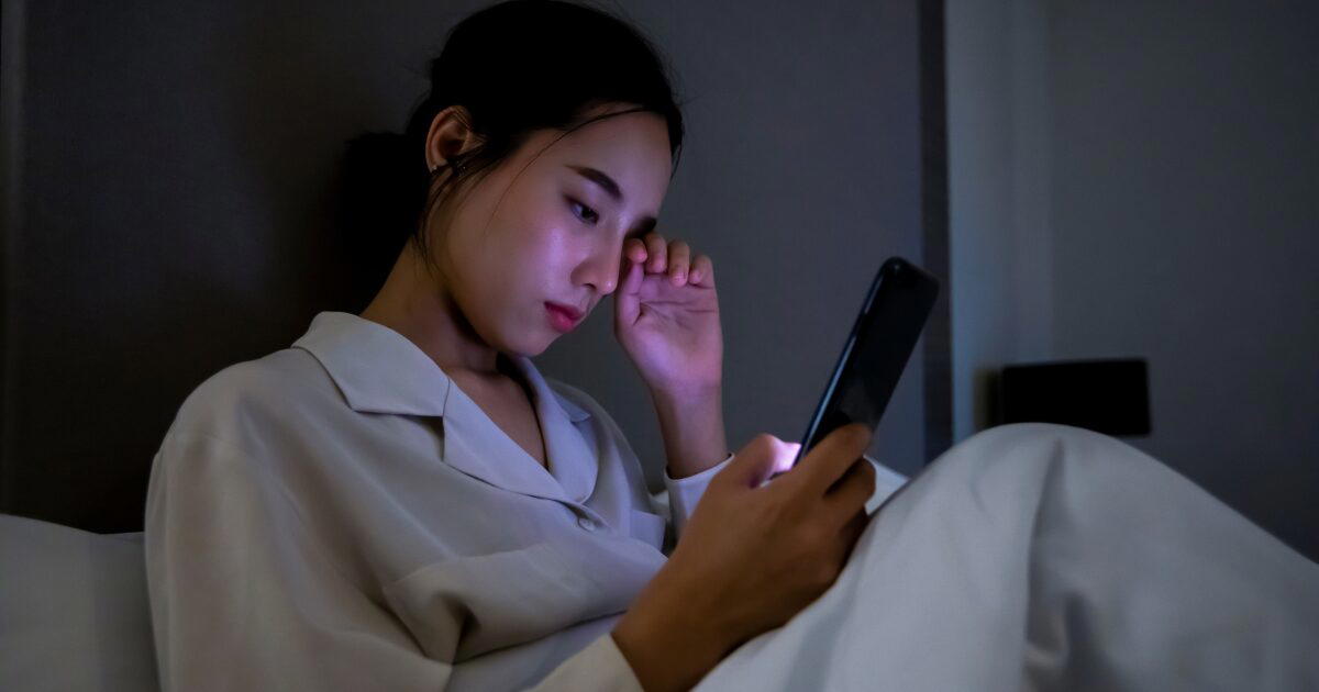 woman using phones at night