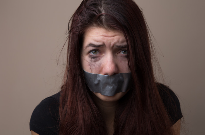 Woman's mouth covered with tape