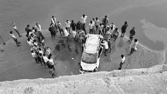 Wreckage of car that fell from unfinished bridge in india