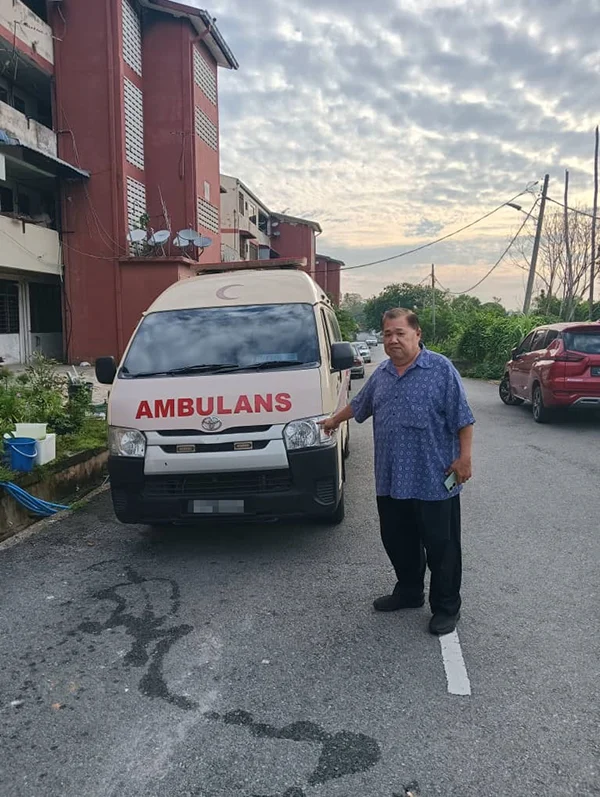 Ye posing with ambulance
