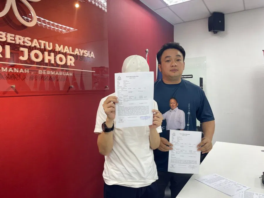 Zhu covering his face at press conference